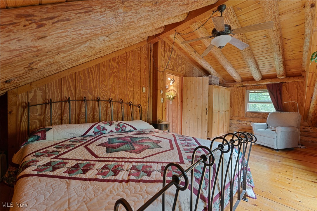 14 Clingan Road Struthers, OH 44471 - Photo 26 of 50 Bedroom with wooden walls, light wood-style flooring, a ceiling fan, and wood ceiling