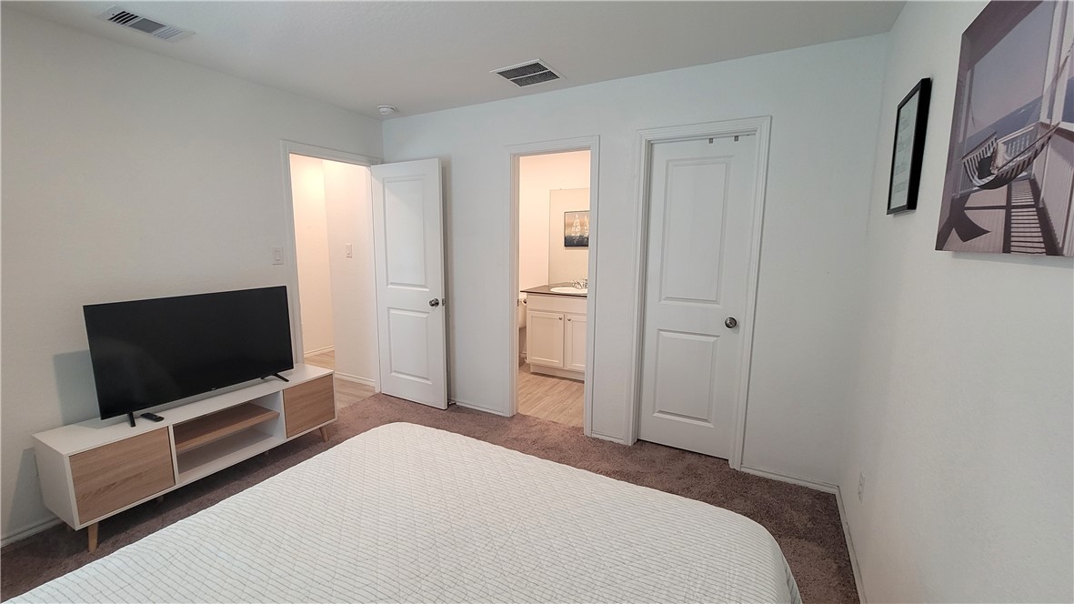 3206 Lancer Street Robstown, TX 78380 - Photo 14 of 23 a bedroom with a bed and a flat screen tv