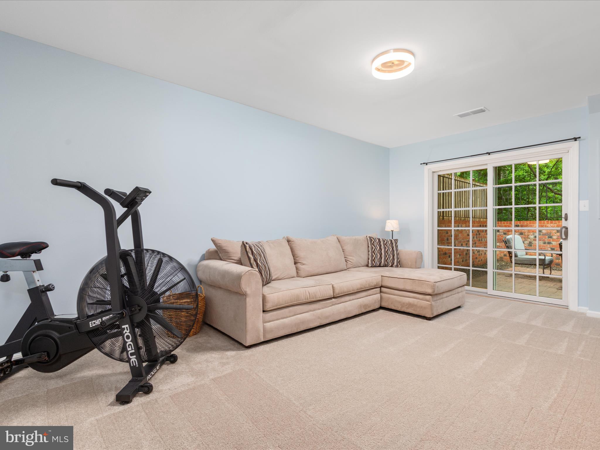 2272 Gunsmith Square Reston, VA 20191 - Photo 19 of 63 a living room with furniture a window and gym equipment