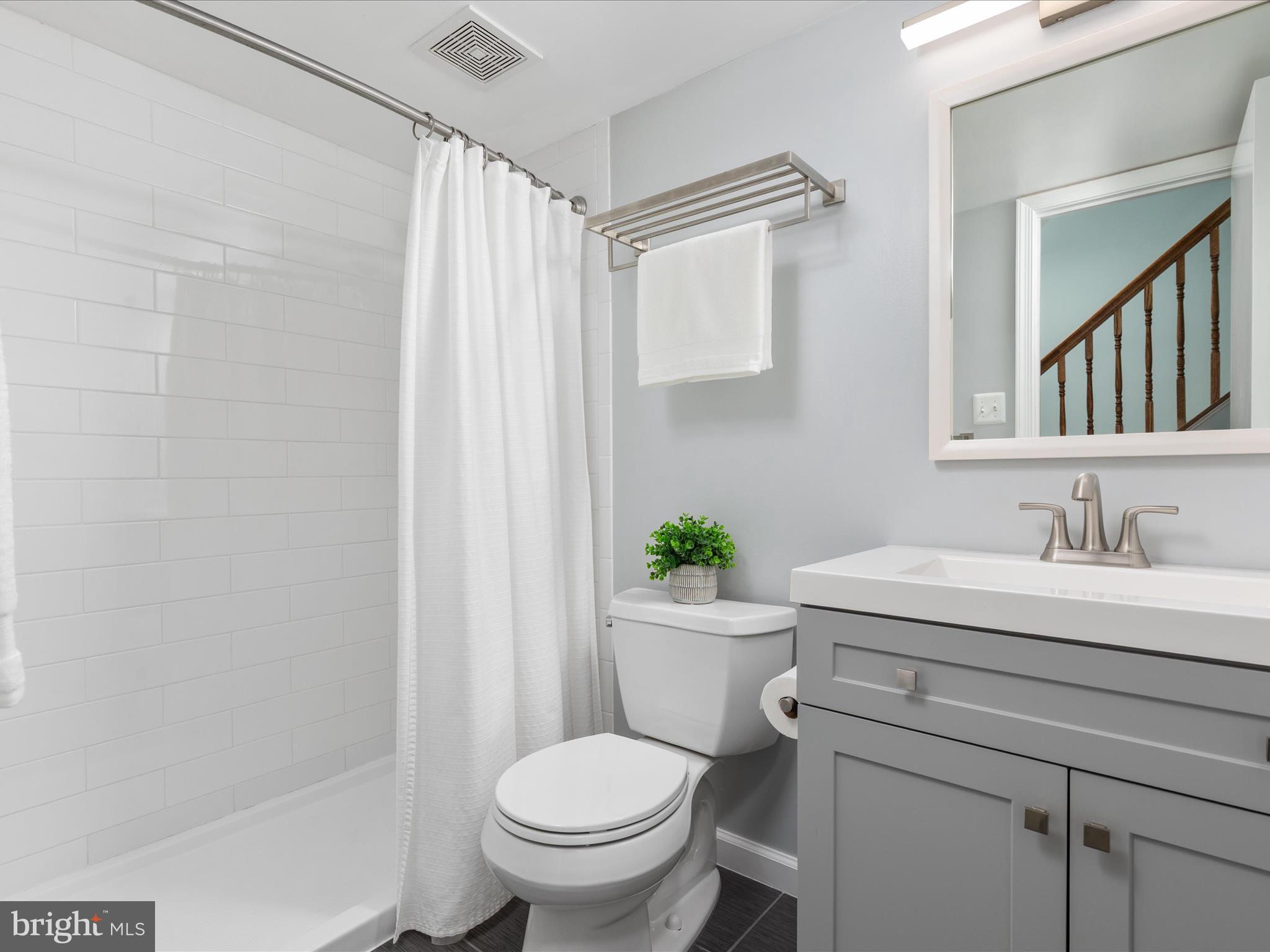 2272 Gunsmith Square Reston, VA 20191 - Photo 22 of 63 a bathroom with a granite countertop sink toilet and a mirror