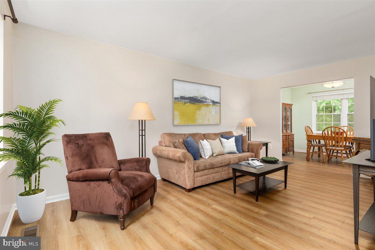 2272 Gunsmith Square Reston, VA 20191 - Photo 5 of 63 a living room with furniture and a potted plant on coffee table