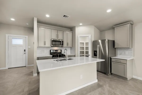 a kitchen with stainless steel appliances a refrigerator stove microwave and sink