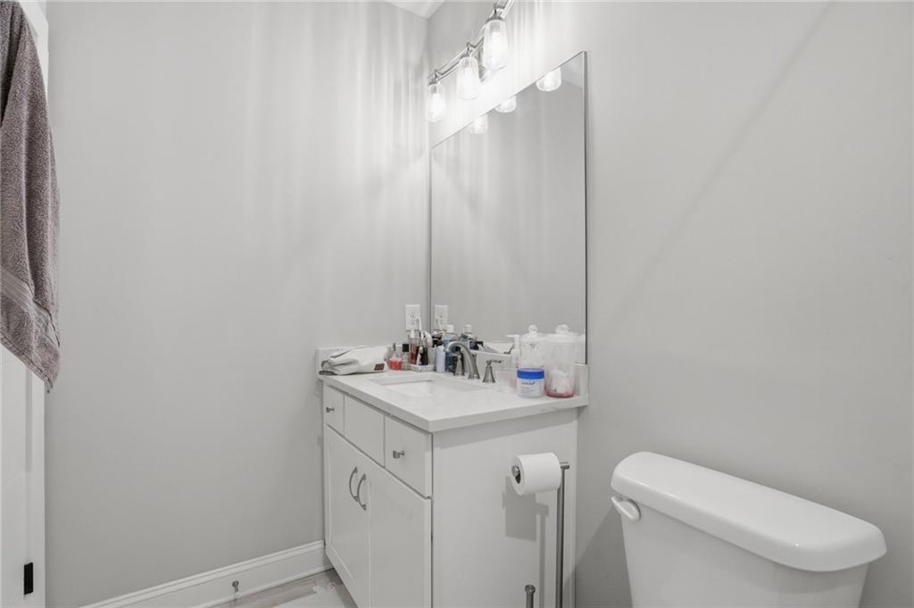 3020 Wallace Road Buford, GA 30519 - Photo 41 of 66 a bathroom with a sink vanity mirror and toilet