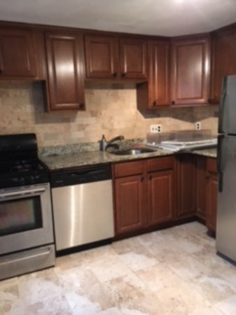 22 Crehore Road Boston, MA 02467 - Photo 3 of 9 a kitchen with granite countertop a sink and cabinets