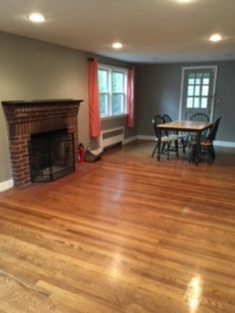 22 Crehore Road Boston, MA 02467 - Photo 6 of 9 an empty room with fireplace and windows