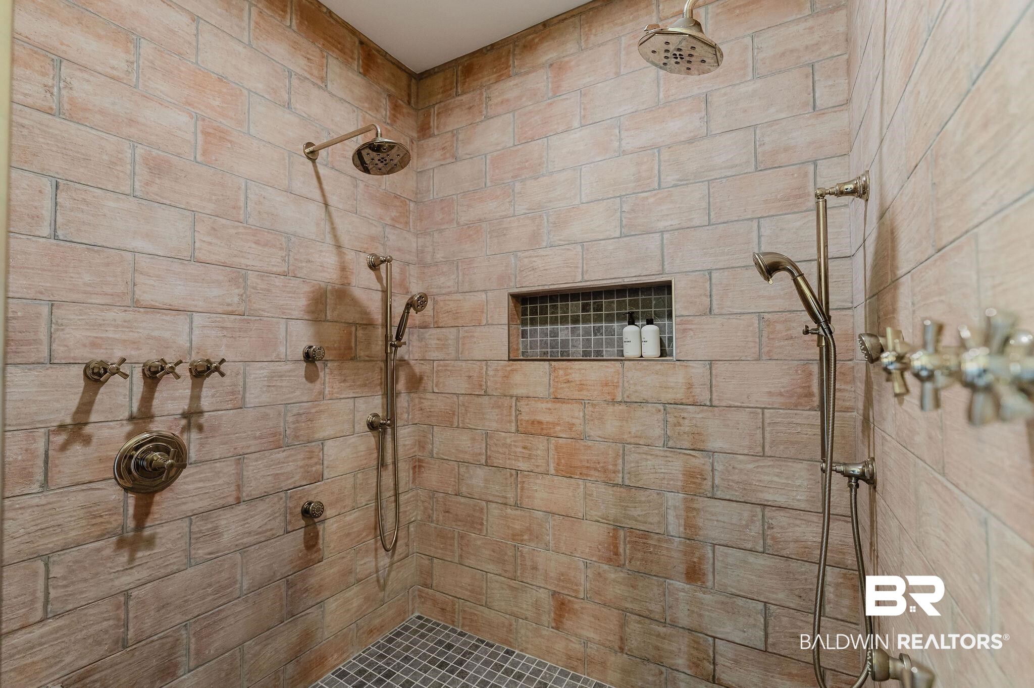 7872 Calverton Street Foley, AL 36535 - Photo 20 of 76 Expansive shower stall featuring light-toned brick-patterned wall tiling and coordinating tile flooring