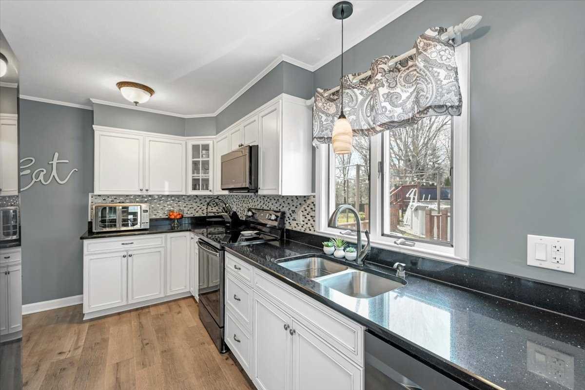 6 Broadview Road Poughkeepsie, NY 12603 - Photo 15 of 35 a kitchen with granite countertop a sink and white cabinets