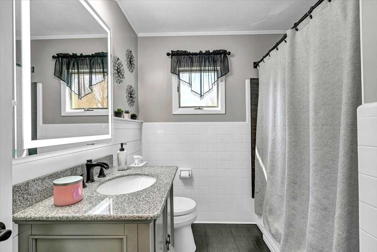 6 Broadview Road Poughkeepsie, NY 12603 - Photo 20 of 35 a bathroom with a granite countertop sink toilet a mirror and shower