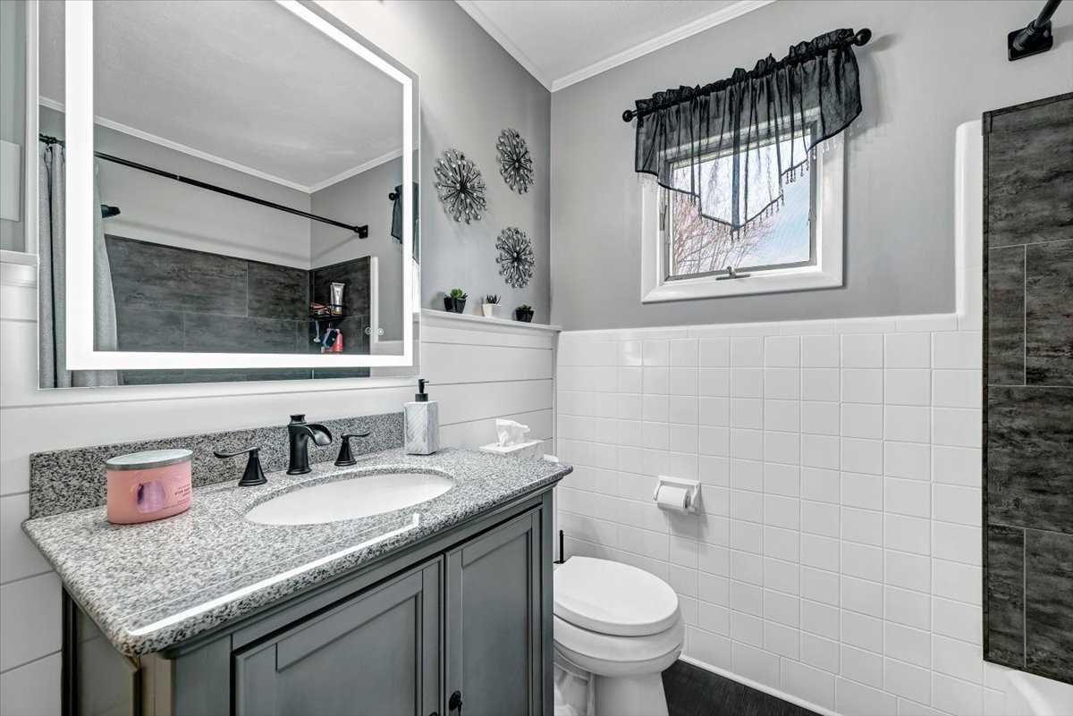 6 Broadview Road Poughkeepsie, NY 12603 - Photo 21 of 35 a bathroom with a granite countertop sink a toilet and a mirror