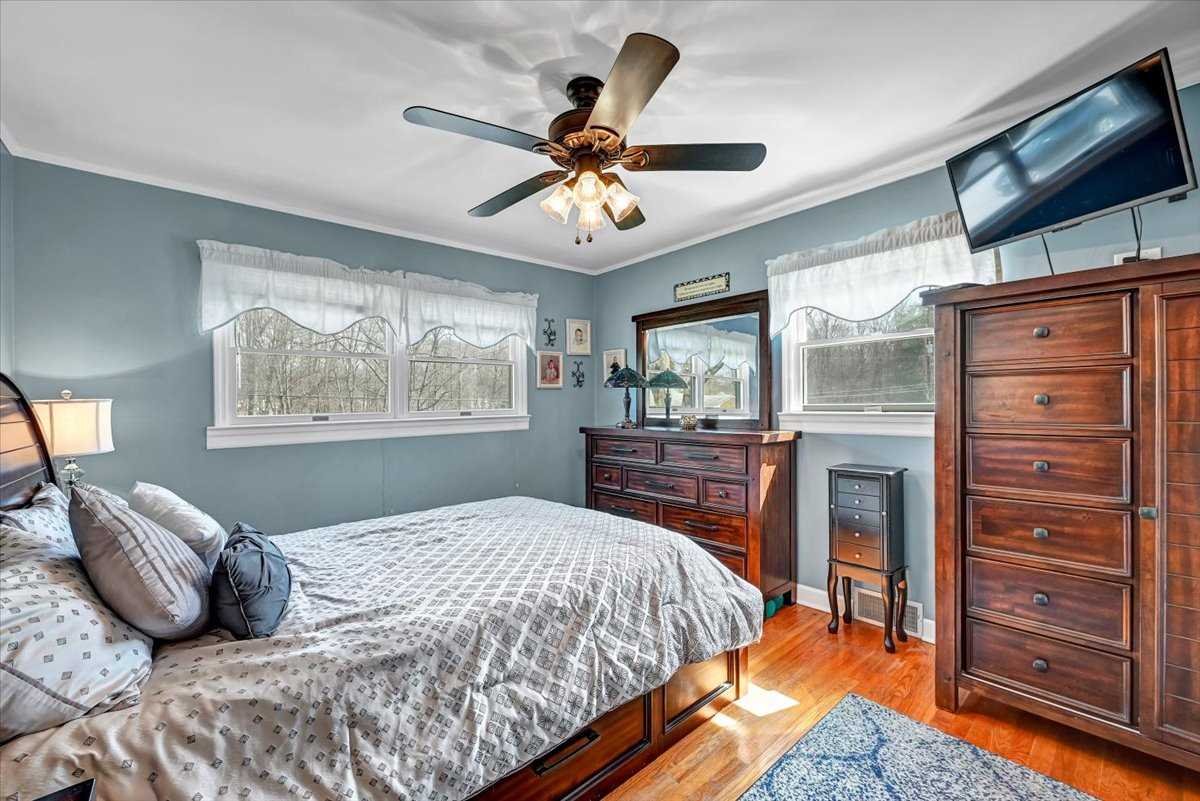 6 Broadview Road Poughkeepsie, NY 12603 - Photo 23 of 35 a bedroom with a bed and a chandelier