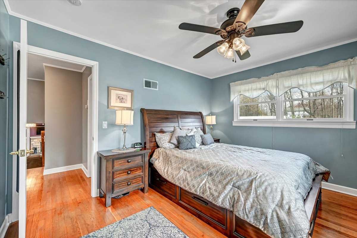 6 Broadview Road Poughkeepsie, NY 12603 - Photo 24 of 35 a bedroom with a bed and a chandelier