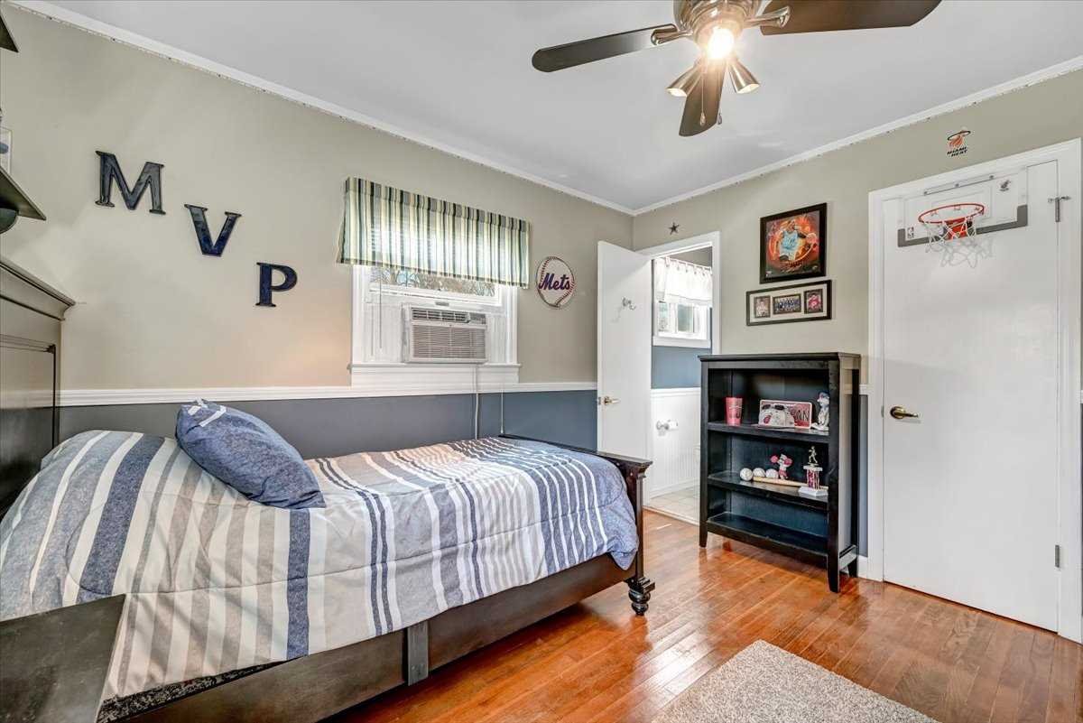 6 Broadview Road Poughkeepsie, NY 12603 - Photo 26 of 35 a bedroom with a bed and a chandelier