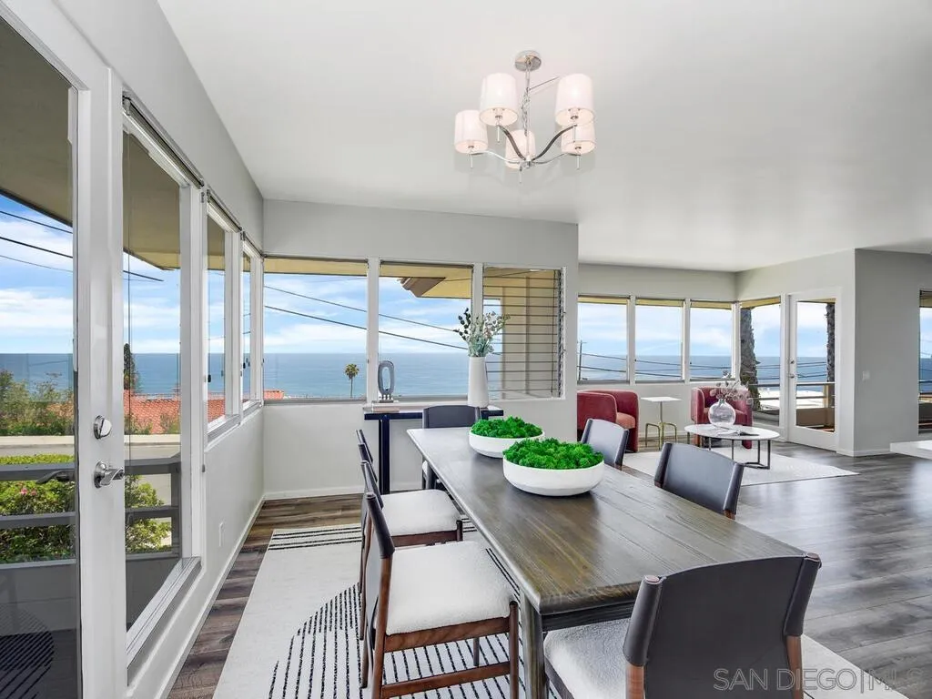 1010 La Jolla Rancho Road La Jolla, CA 92037 - Photo 11 of 35 a view of a dining room with furniture a potted plant and a floor to ceiling window