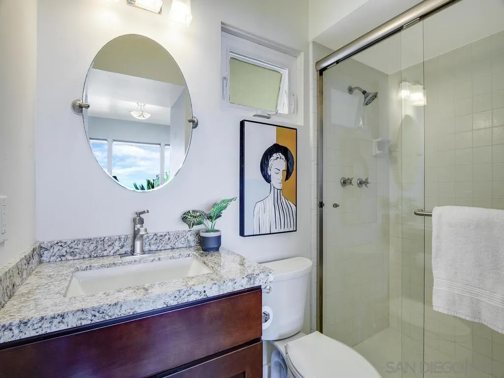 1010 La Jolla Rancho Road La Jolla, CA 92037 - Photo 15 of 35 a bathroom with a granite countertop sink and a mirror