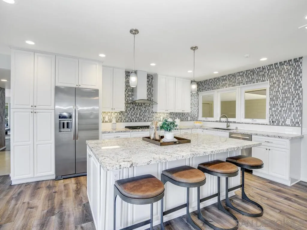 1010 La Jolla Rancho Road La Jolla, CA 92037 - Photo 8 of 35 a kitchen with granite countertop kitchen island cabinets and refrigerator