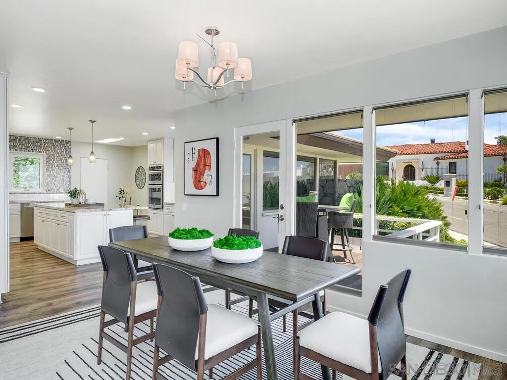 1010 La Jolla Rancho Road La Jolla, CA 92037 - Photo 10 of 35 a view of a dining room with furniture a chandelier and wooden floor