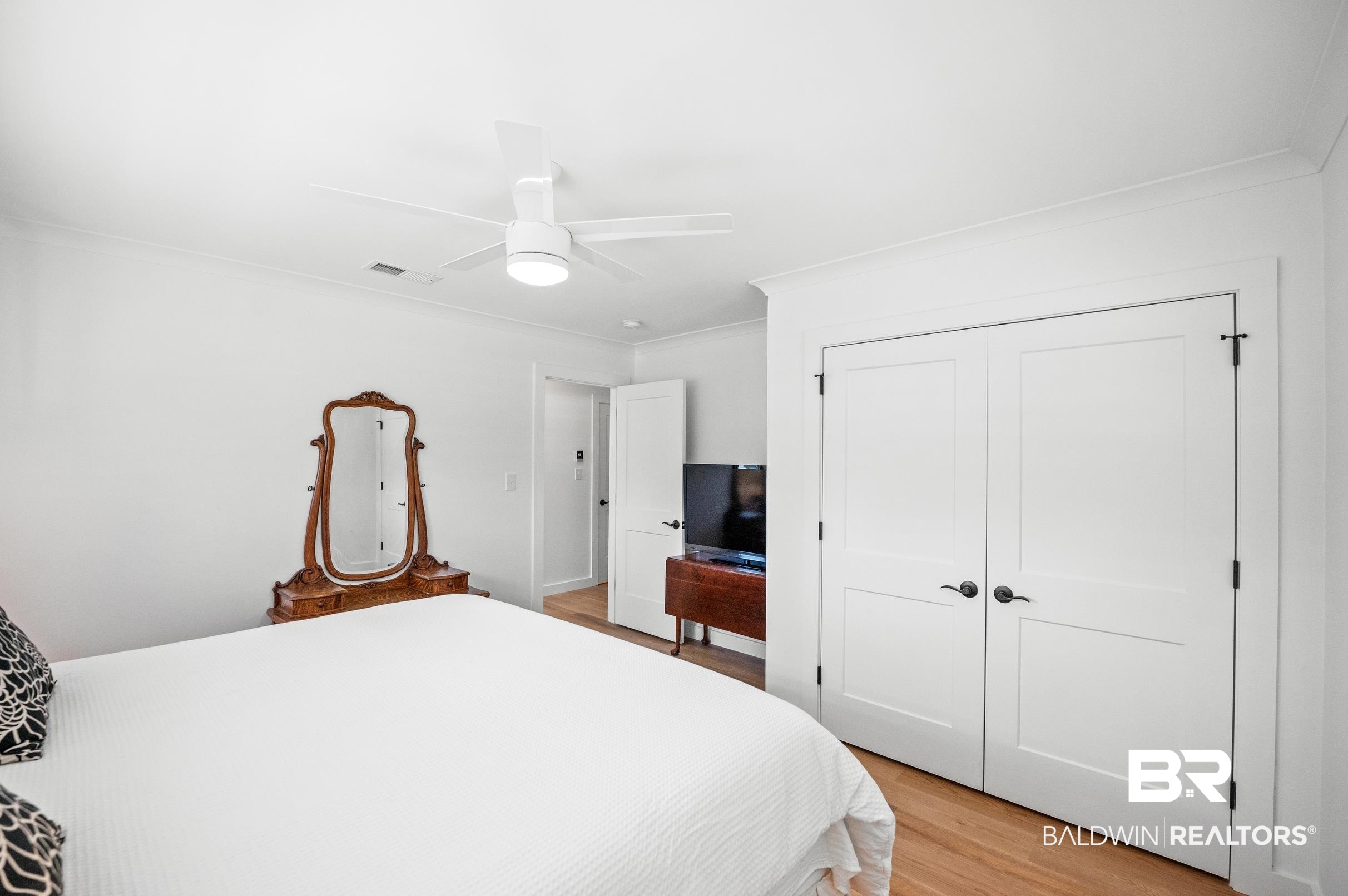 9459 Soldier Creek Road Lillian, AL 36549 - Photo 22 of 54 Bedroom with ornamental molding, a closet, light wood-style flooring, and visible vents