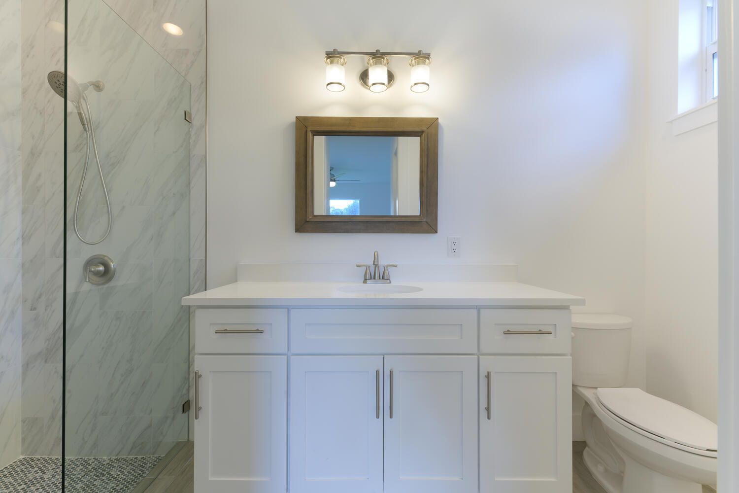 18050 Limestone Creek Road Jupiter, FL 33458 - Photo 13 of 26 a bathroom with a sink a toilet and a mirror