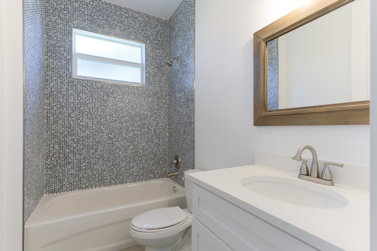 18050 Limestone Creek Road Jupiter, FL 33458 - Photo 15 of 26 a bathroom with a sink a toilet and bathtub