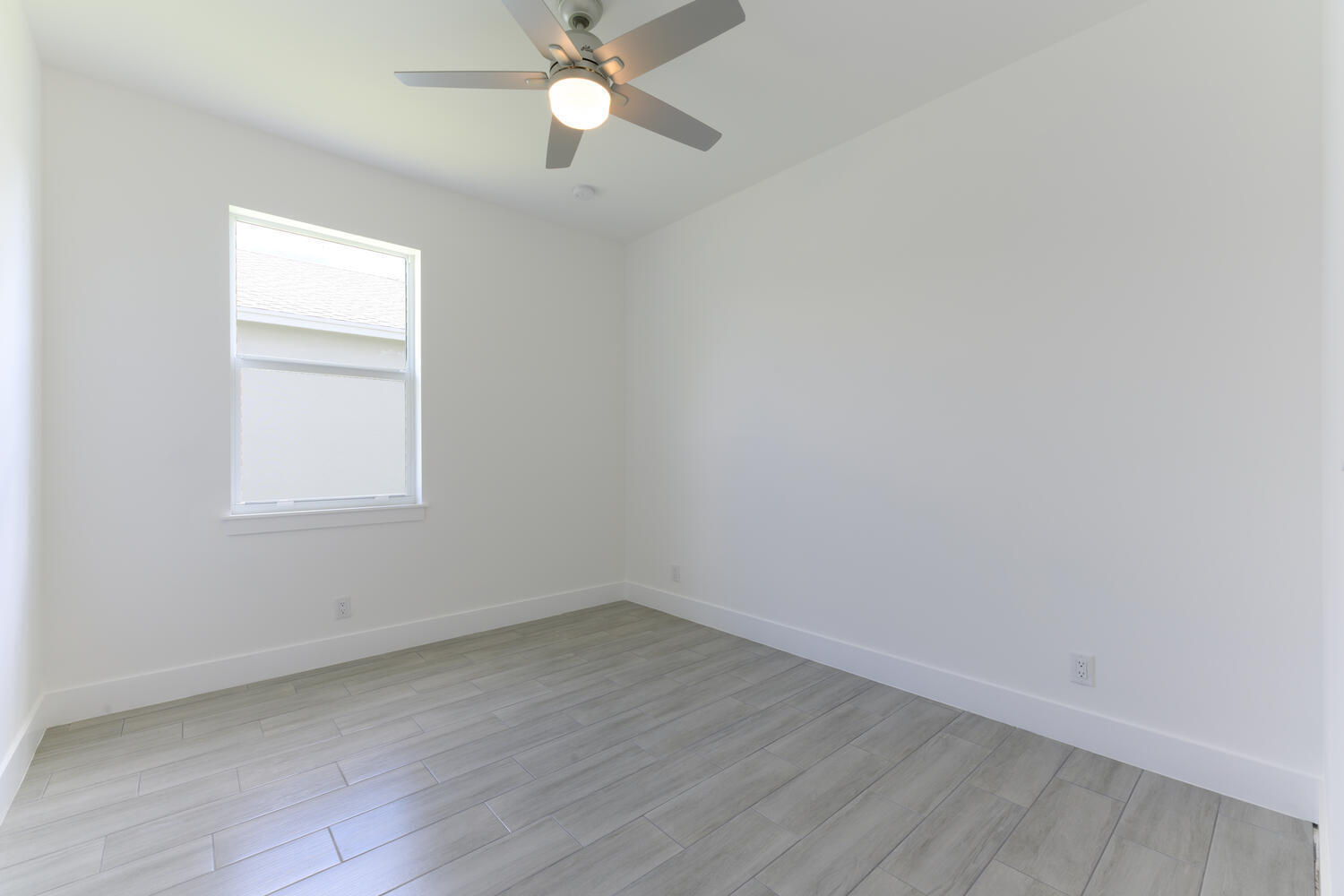 18050 Limestone Creek Road Jupiter, FL 33458 - Photo 21 of 26 wooden floor in an empty room with a window