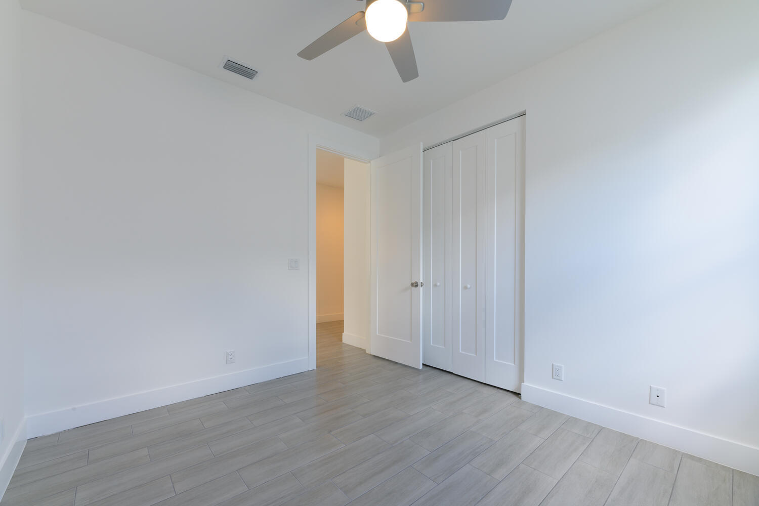 18050 Limestone Creek Road Jupiter, FL 33458 - Photo 22 of 26 a view of an empty room with wooden floor