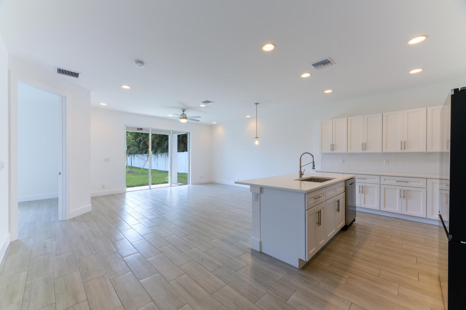 18050 Limestone Creek Road Jupiter, FL 33458 - Photo 6 of 26 a large kitchen with stainless steel appliances granite countertop a stove a sink and a refrigerator