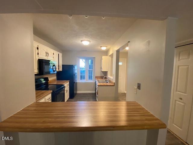 8129 McGuire Drive Raleigh, NC 27616 - Photo 6 of 14 a view of kitchen with kitchen island dining table and chairs