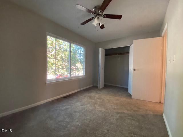 8129 McGuire Drive Raleigh, NC 27616 - Photo 8 of 14 an empty room with windows and fan
