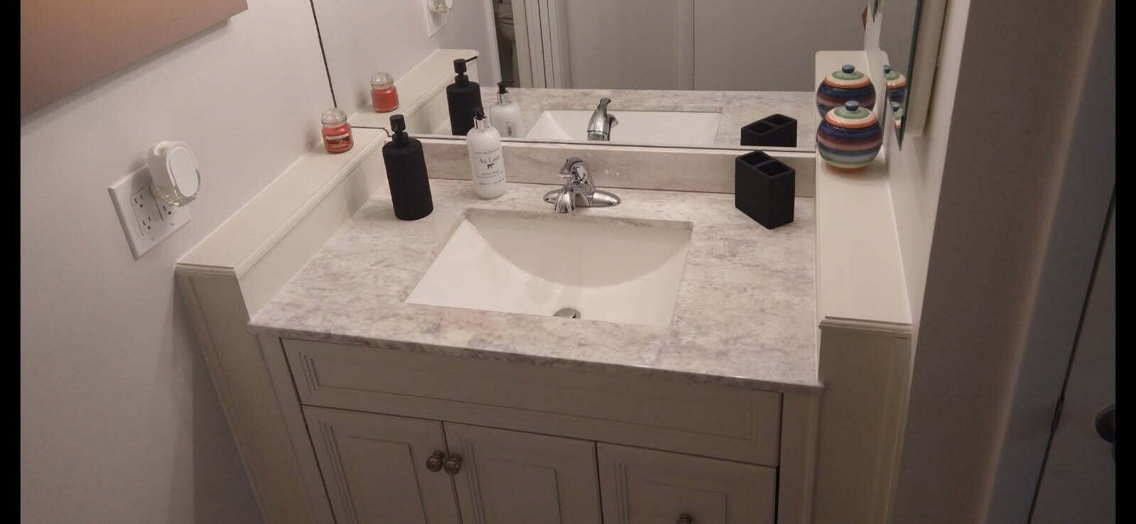 500 Ocean Trail Way, Unit 307 Jupiter, FL 33477 - Photo 14 of 18 a bathroom with a granite countertop sink and a mirror