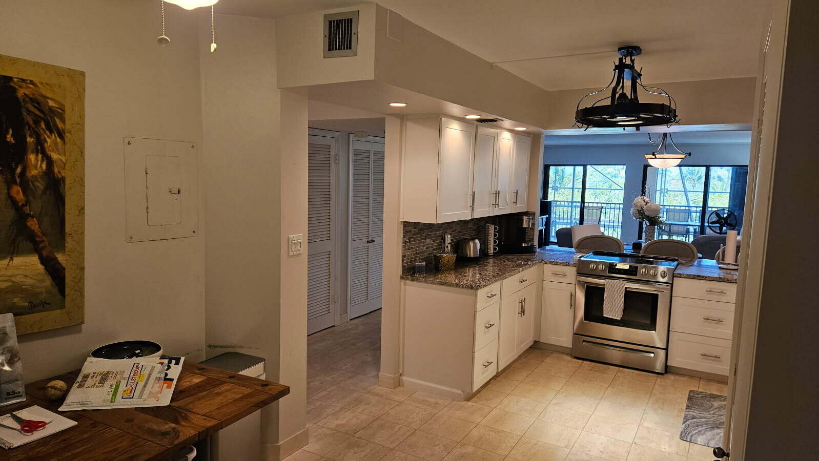 500 Ocean Trail Way, Unit 307 Jupiter, FL 33477 - Photo 4 of 18 a kitchen with stainless steel appliances kitchen island granite countertop a stove and a sink