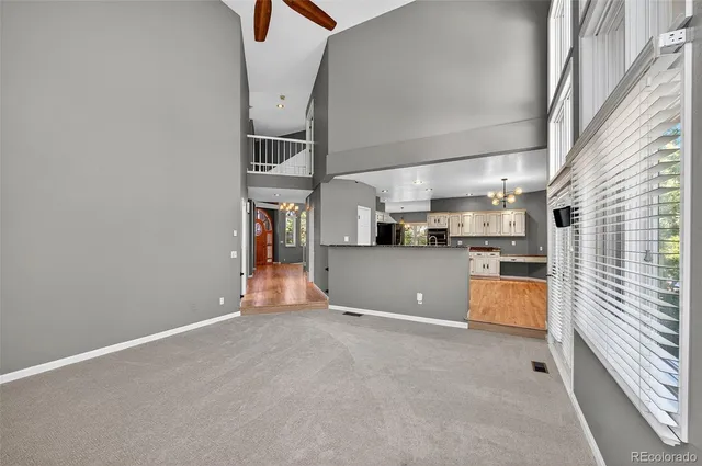 a view of a kitchen with furniture and an empty room