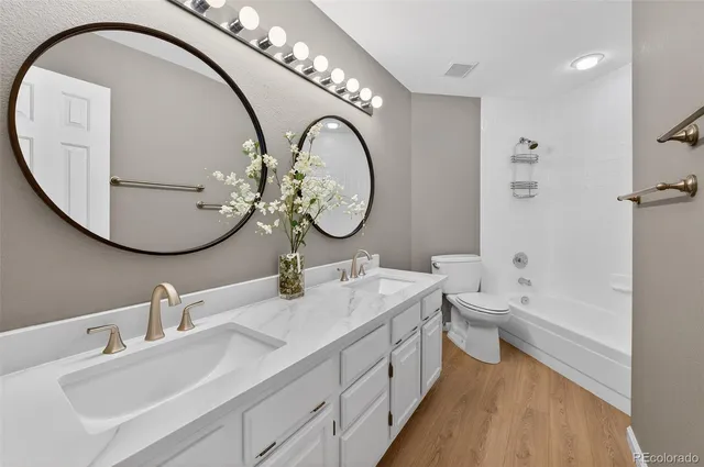 a spacious bathroom with a double vanity sink and a mirror