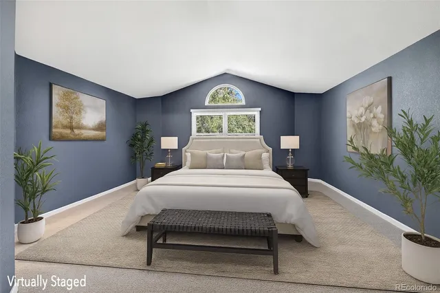 a bedroom with a bed and a potted plant