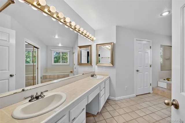 a spacious bathroom with a double vanity sink mirror and double