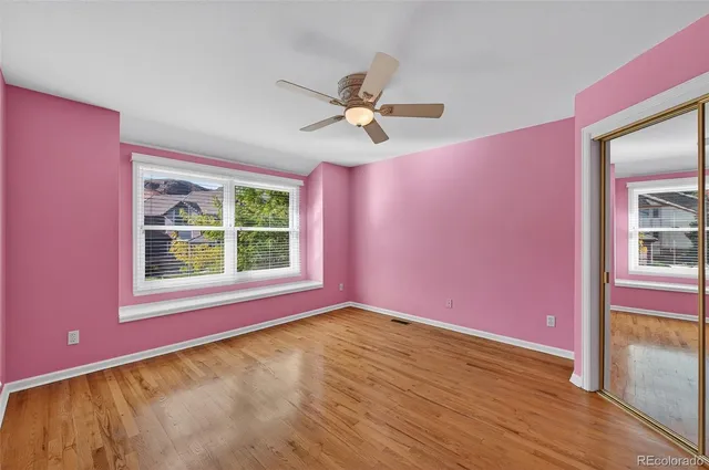 a view of a livingroom with a ceiling fan and window