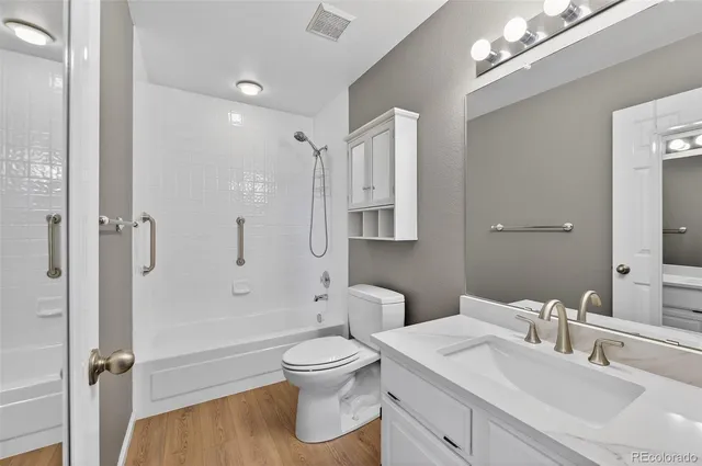 a bathroom with a sink toilet tub and shower