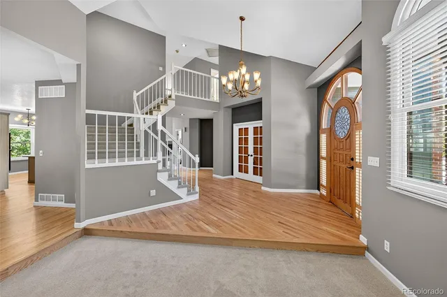 a bedroom with a large bed and a chandelier