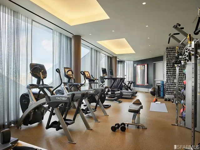 a gym room with lots of gym equipment