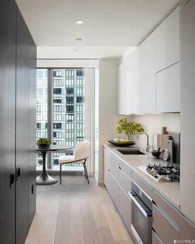 a kitchen with sink cabinets and appliances