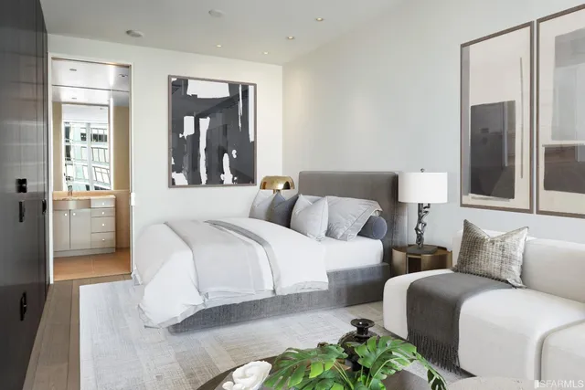 a bedroom with a bed couch and a large window