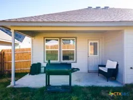 a view of a backyard with a patio