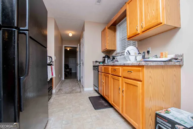 a hallway with washer dryer and cabinets