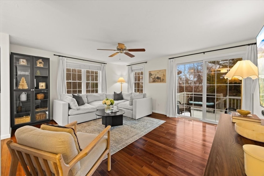 a living room with furniture a table and a large window