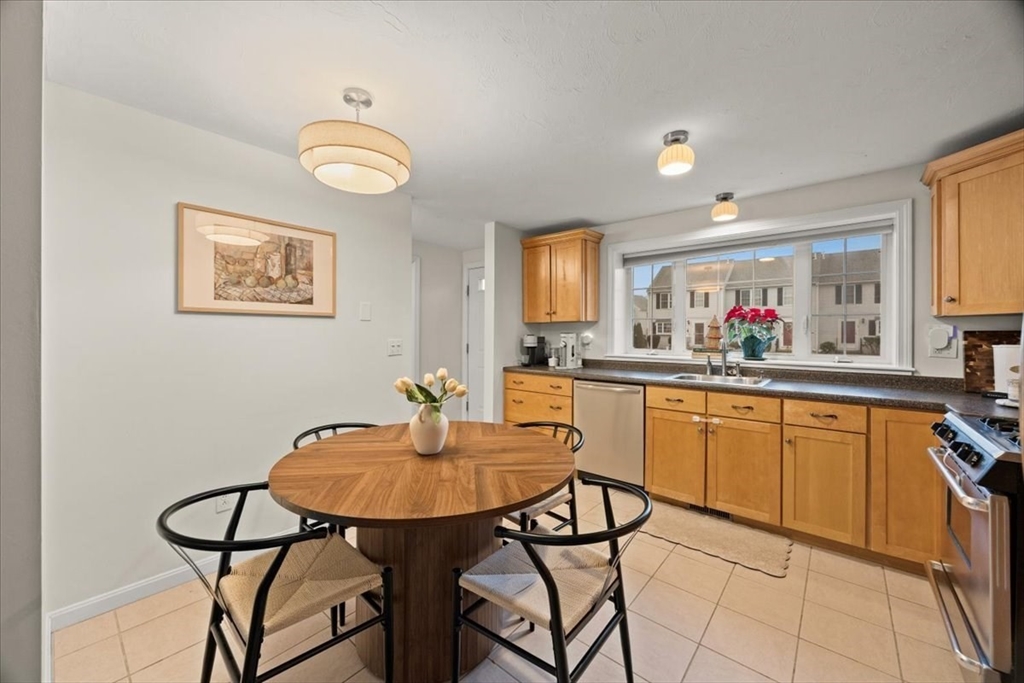 2697 Cranberry Highway, Unit 28 Wareham, MA 02571 - Photo 11 of 37 a kitchen with stainless steel appliances granite countertop a sink cabinets and living room view