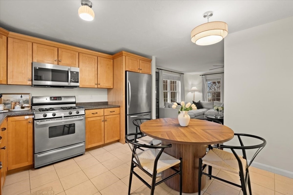 2697 Cranberry Highway, Unit 28 Wareham, MA 02571 - Photo 13 of 37 a kitchen with stainless steel appliances a stove refrigerator sink and microwave