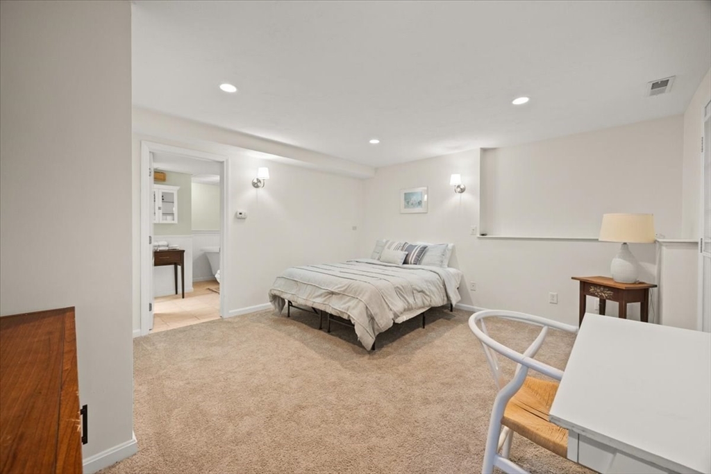 2697 Cranberry Highway, Unit 28 Wareham, MA 02571 - Photo 25 of 37 a spacious bedroom with a bed and a lamp
