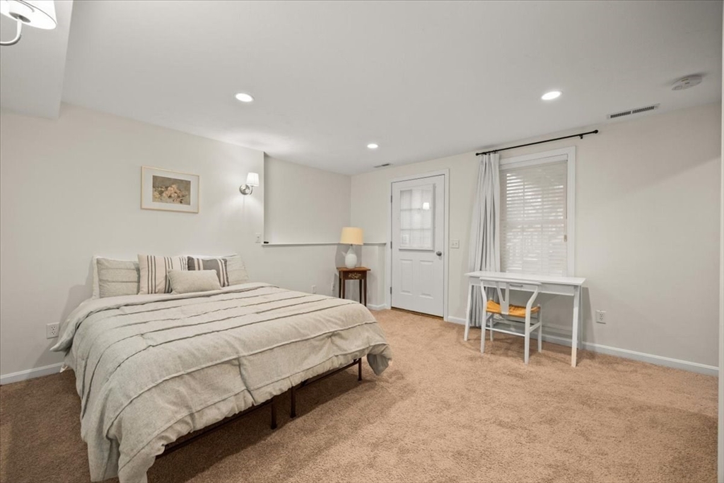 2697 Cranberry Highway, Unit 28 Wareham, MA 02571 - Photo 26 of 37 a bedroom with a bed and a chair