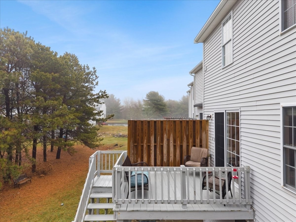 2697 Cranberry Highway, Unit 28 Wareham, MA 02571 - Photo 32 of 37 a view of a roof deck with wooden fence and floor