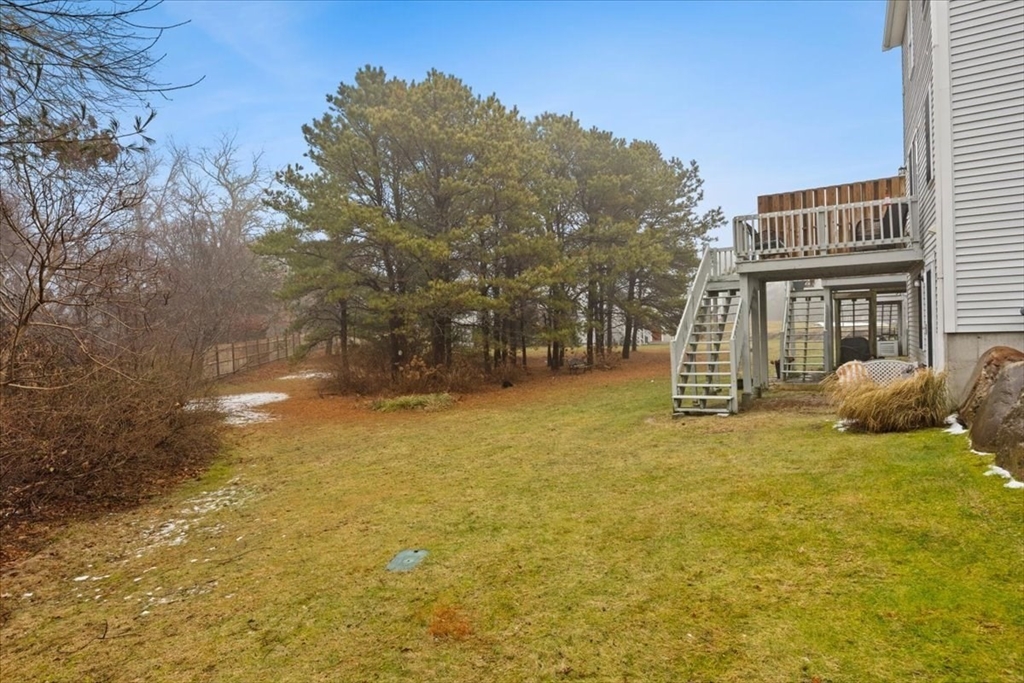 2697 Cranberry Highway, Unit 28 Wareham, MA 02571 - Photo 33 of 37 a backyard of a house with large trees