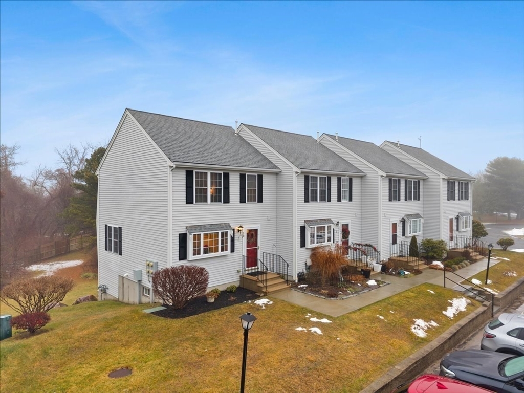 2697 Cranberry Highway, Unit 28 Wareham, MA 02571 - Photo 5 of 37 a front view of a house with yard outdoor seating and covered with trees
